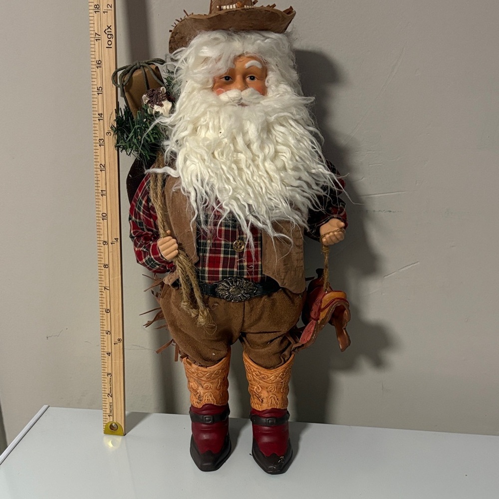 This is a Karen Didion Originals Cowboy Santa figurine 17-19 inches tall